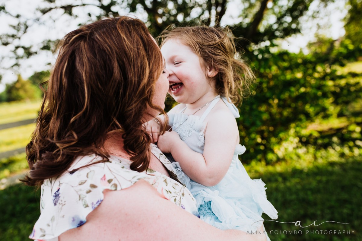 mother kissing daughter on the nose while child laughs, photographed by Anika Colombo Photography