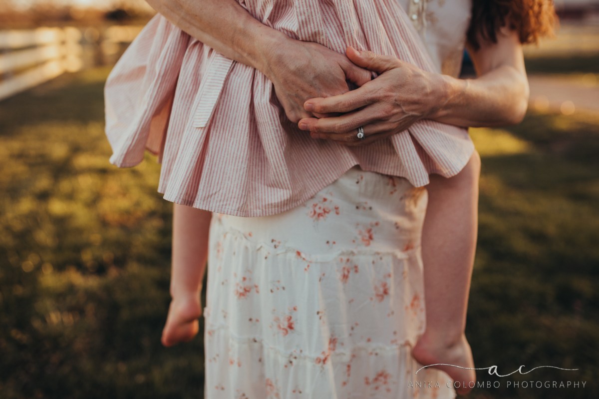 Mothers hands holding daughter
