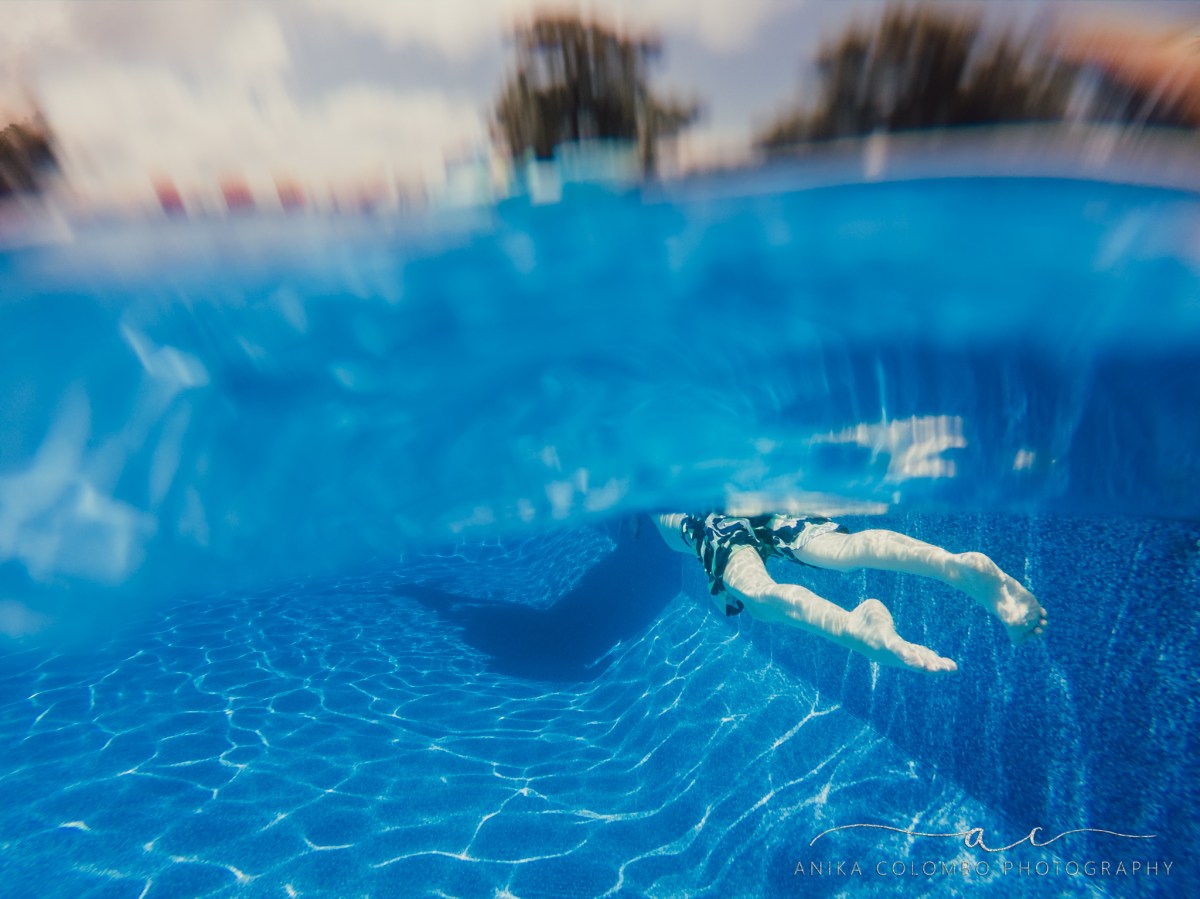 underwater photograph of kids swimming