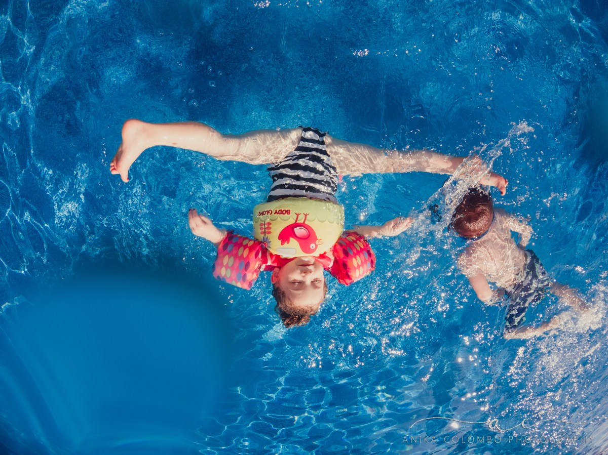 underwater photograph girl flipping into a pool