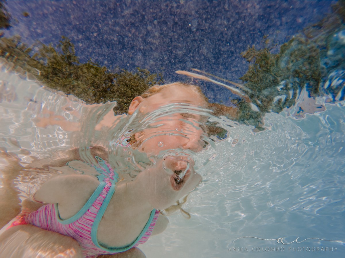 underwater photography little girl blowing bubbles in a pool