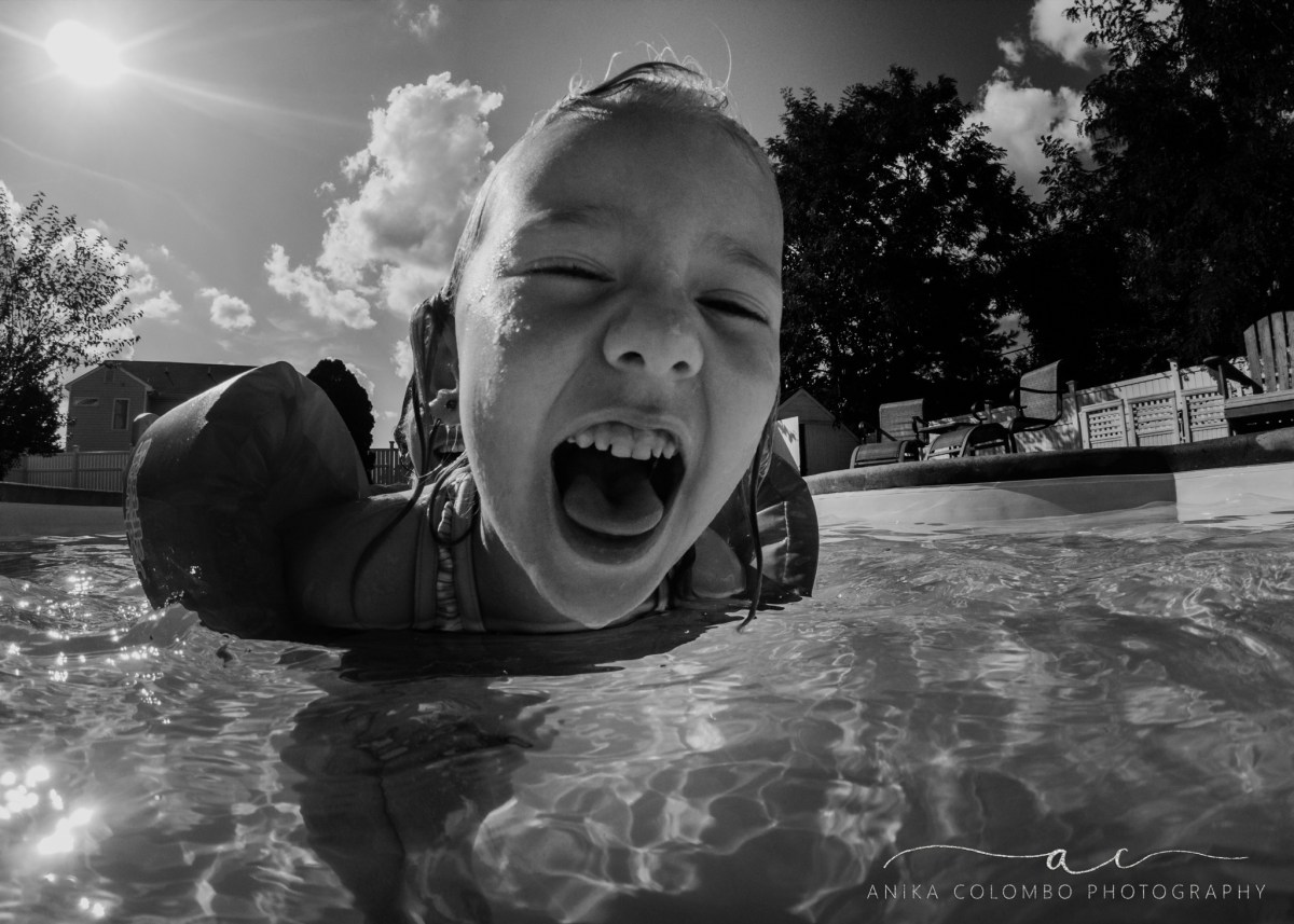 little girl laughing into camera
