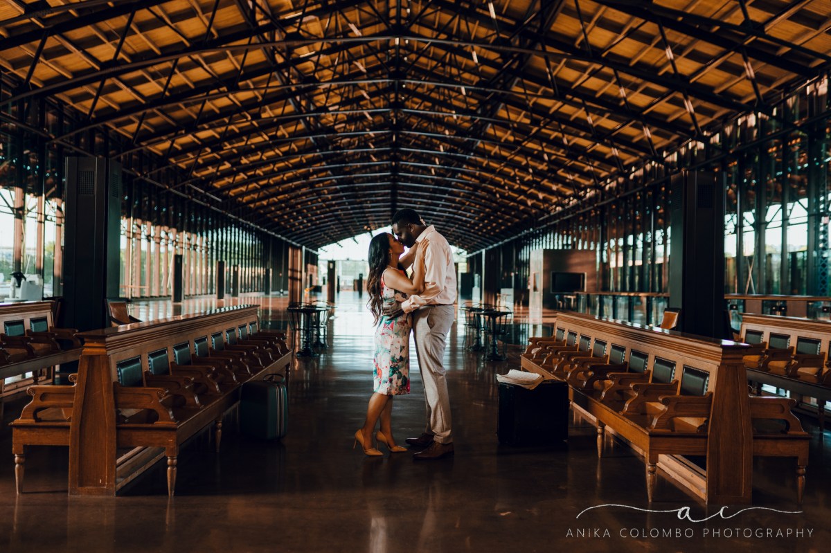 man and woman embracing in front of empty benches at mainstreet station in richmond va