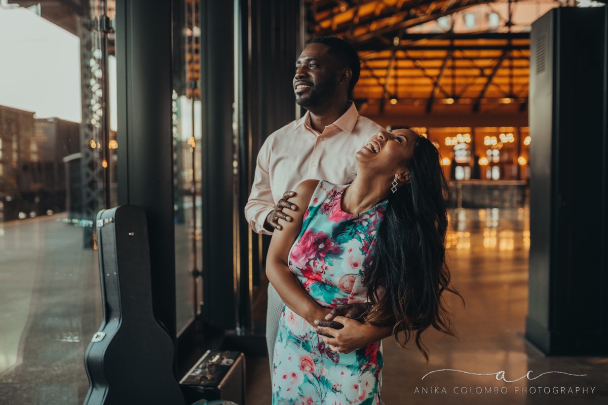 man holding female as she looks back at him and laughs in mainstreet station in richmond va