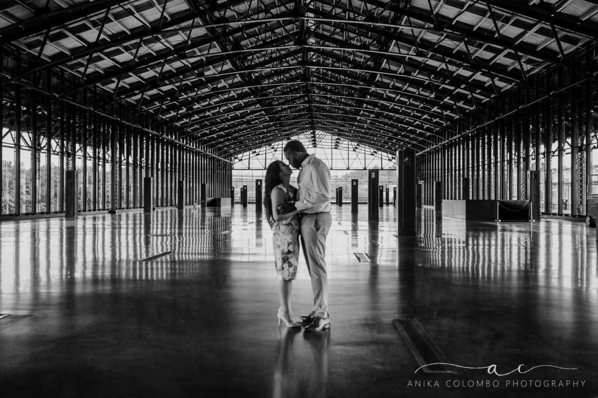 black and white photo of a couple embracing in the center of mainstreet station in richmond va